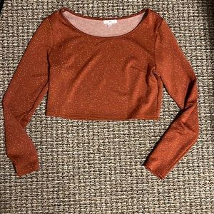 Burnt orange top with tiny white heart pattern. Long sleeved and cropped.
